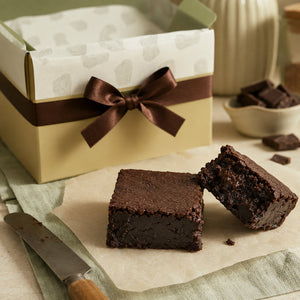 Ruth’s extra-fudgy brownies with dense chocolate centers and cream and sage gift packaging