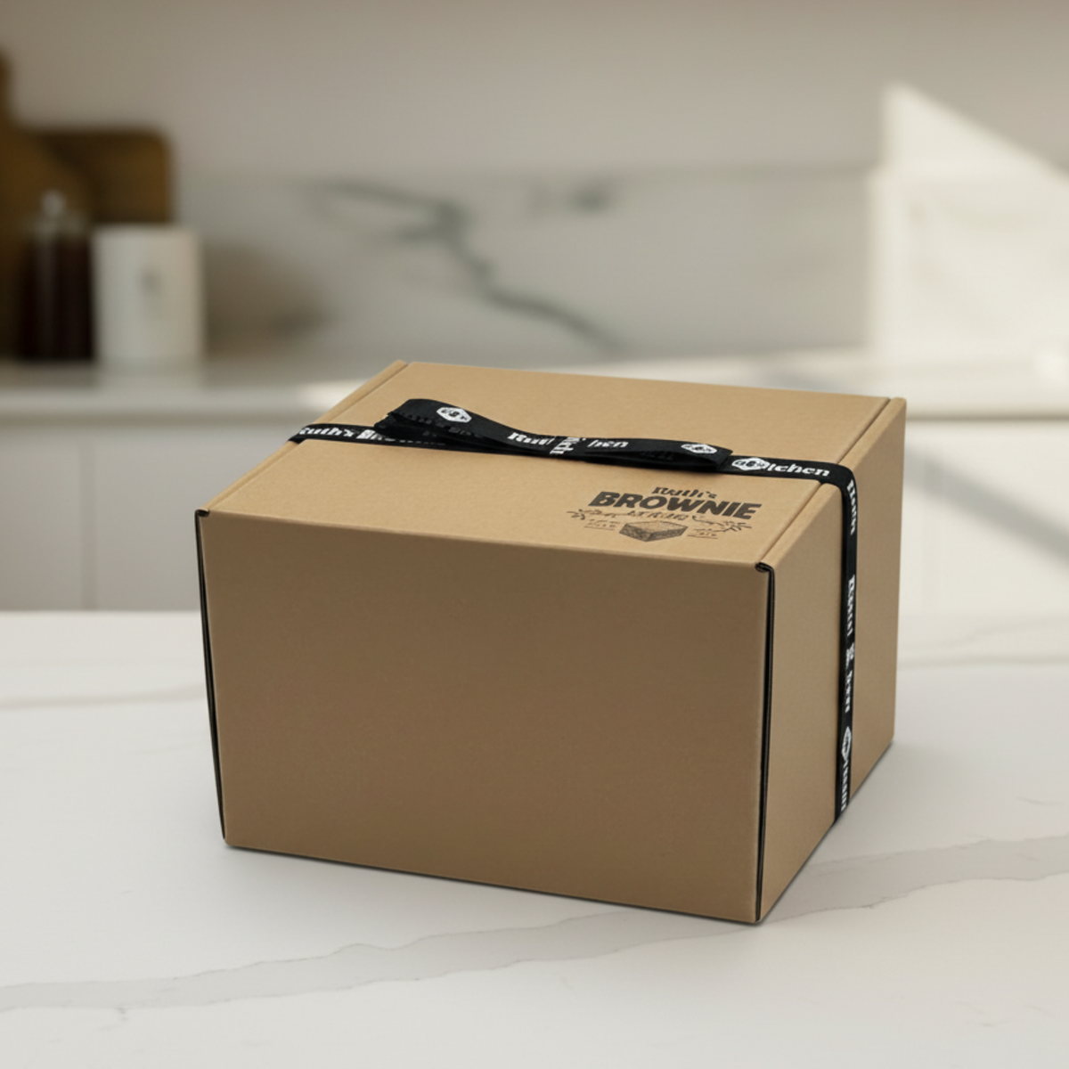 Ruth’s heavy kraft gift box finished with a black branded ribbon and printed logo