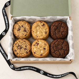 Overhead view of assorted chocolate chunk, white chocolate cranberry and dark chocolate cookies in Ruth’s gift box