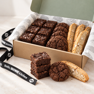 Chocolate chunk brownies, chocolate cookie and almond biscotti beside Ruth’s open kraft gift box