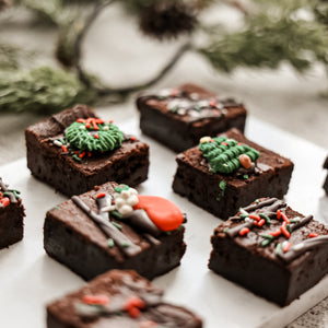 Christmas Extra Fudgy Brownies with festive chocolate drizzles, wreaths and holiday sprinkles