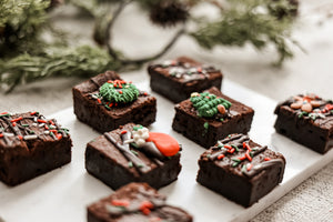 Christmas Extra Fudgy Brownies with festive chocolate drizzles, wreaths and holiday sprinkles