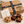 Closed Ruth's Brownie Kitchen kraft gift box with original logo and black RBK ribbon, alongside assorted gluten-free brownies and cookie