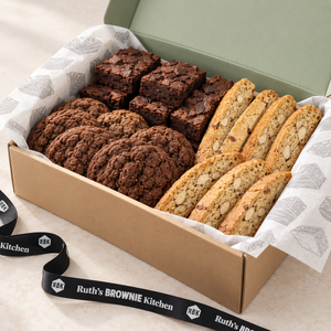 Angled view of Ruth’s large dessert gift box with brownies, cookies, biscotti and branded tissue paper